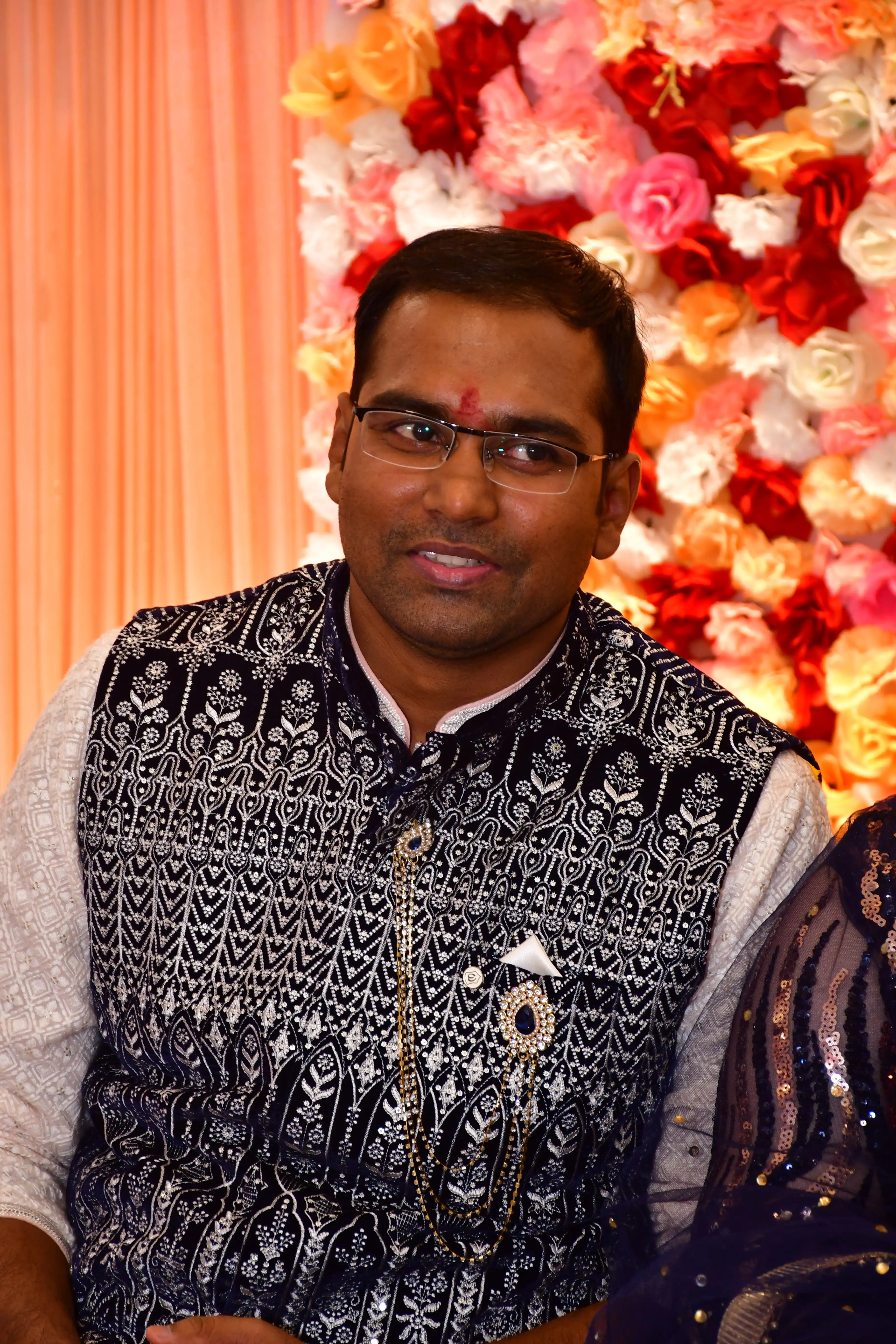 Bride and groom under a floral arch